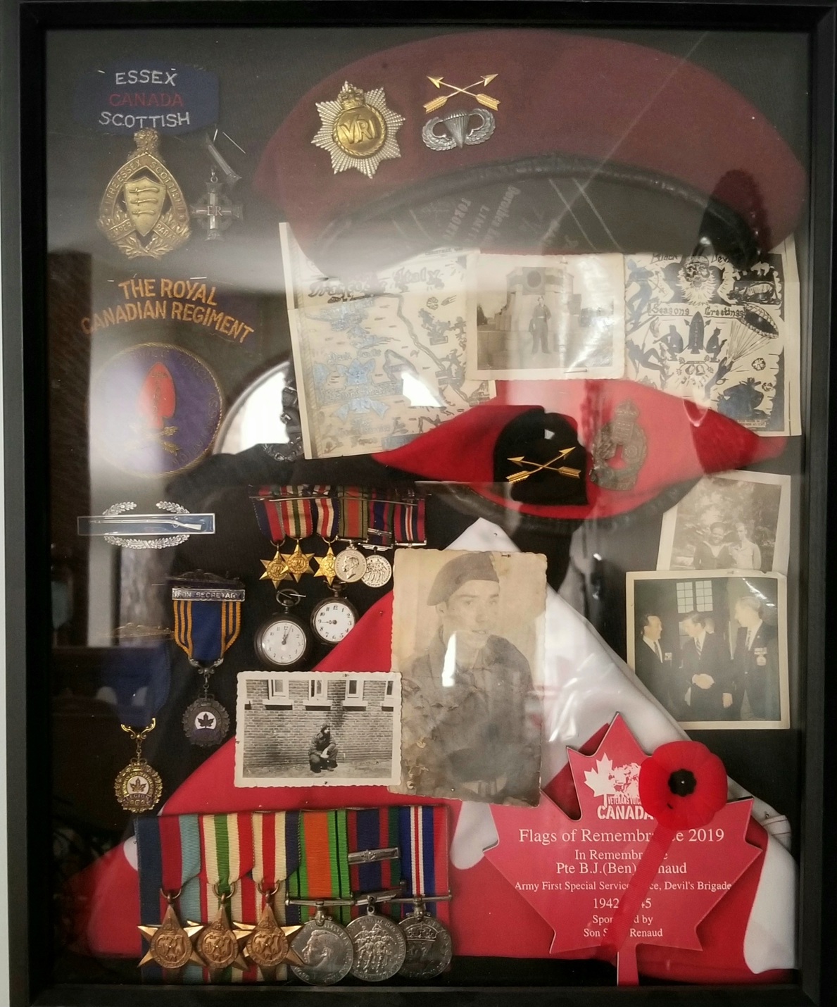 A shadowbox featuring a variety of WWII items.